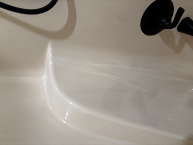 Freshly cleaned bathtub with a bright, polished finish